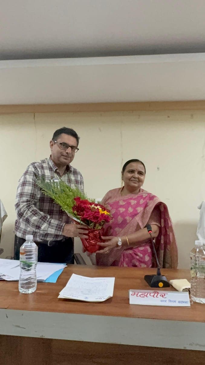 Person sitting by mountain lake with boats